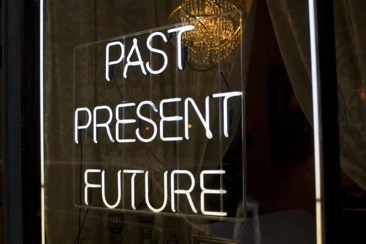 neon sign which reads "Past, Present, Future"